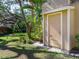 Exterior storage shed in the backyard with tropical trees creating shade at 4869 Village Gardens Dr # 189, Sarasota, FL 34234