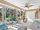 Sunroom features tile floors, glass windows, comfortable seating, a ceiling fan, and natural views at 4869 Village Gardens Dr # 189, Sarasota, FL 34234