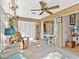 Bright sunroom with tile flooring, sliding doors, and comfortable seating near a table with white chairs at 4869 Village Gardens Dr # 189, Sarasota, FL 34234