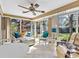 Inviting sunroom with abundant windows, tile flooring, comfortable seating, and lush backyard views at 4869 Village Gardens Dr # 189, Sarasota, FL 34234