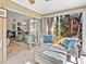 Bright sunroom featuring plush seating, glass windows, and an open view of the interior spaces at 4869 Village Gardens Dr # 189, Sarasota, FL 34234