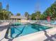 Community swimming pool offers a refreshing escape with ample seating and clear blue water at 4869 Village Gardens Dr # 189, Sarasota, FL 34234
