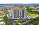 A high-rise building overlooking a beautiful bay with lush greenery and clear blue skies at 501 Haben Blvd # 506, Palmetto, FL 34221