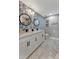 Bathroom with double sinks, granite counters, attractive wall paper and modern black fixtures at 501 Haben Blvd # 506, Palmetto, FL 34221