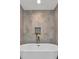 Close-up of a modern soaking tub faucet and decorative wall niche with plants at 501 Haben Blvd # 506, Palmetto, FL 34221