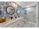 Bathroom featuring double sinks, granite counters, attractive wall paper and modern black fixtures at 501 Haben Blvd # 506, Palmetto, FL 34221