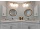 Elegant bathroom featuring dual sink vanity, designer wallpaper, decorative lighting, and modern fixtures at 501 Haben Blvd # 506, Palmetto, FL 34221