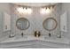 Elegant bathroom featuring dual sink vanity, designer wallpaper, decorative lighting, and modern fixtures at 501 Haben Blvd # 506, Palmetto, FL 34221