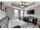 Cozy bedroom with a comfortable sofa bed, a large TV, and a ceiling fan at 501 Haben Blvd # 506, Palmetto, FL 34221