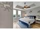 Charming bedroom featuring wood floors, two windows, modern lighting, and stylish decorations at 501 Haben Blvd # 506, Palmetto, FL 34221