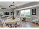 Charming dining area with a round table, chandelier, and large windows overlooking green space at 501 Haben Blvd # 506, Palmetto, FL 34221