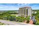 Amazing view of a multi-story luxury building with a tranquil lake and surrounding landscape at 501 Haben Blvd # 506, Palmetto, FL 34221