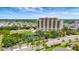 Beautiful view of a multi-story luxury building with a tranquil lake and surrounding landscape at 501 Haben Blvd # 506, Palmetto, FL 34221