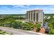 Beautiful view of a multi-story luxury building with a tranquil lake and surrounding landscape at 501 Haben Blvd # 506, Palmetto, FL 34221