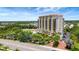 Wonderful view of a multi-story luxury building with a tranquil lake and surrounding landscape at 501 Haben Blvd # 506, Palmetto, FL 34221