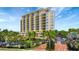 Beautiful building view showcasing balconies and lush landscaping with secure gated entry at 501 Haben Blvd # 506, Palmetto, FL 34221