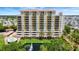 Stunning building view with luxurious amenities, including a pool, pond, and elegant landscaping at 501 Haben Blvd # 506, Palmetto, FL 34221