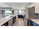 Kitchen featuring navy lower cabinets, white upper cabinets, and an oversized island at 501 Haben Blvd # 506, Palmetto, FL 34221