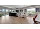 Bright living room with a sectional sofa, chandelier, and large windows at 501 Haben Blvd # 506, Palmetto, FL 34221