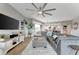 Open living room with a large sectional sofa, modern ceiling fan, and adjacent dining area at 501 Haben Blvd # 506, Palmetto, FL 34221