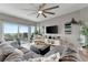 A spacious living room features a large sectional sofa, modern ceiling fan, and balcony access at 501 Haben Blvd # 506, Palmetto, FL 34221