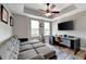 Cozy living room with a comfortable sectional sofa, a large TV, and a ceiling fan at 501 Haben Blvd # 506, Palmetto, FL 34221