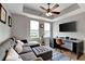 Cozy living room with a comfortable sectional sofa, a large TV, and a ceiling fan at 501 Haben Blvd # 506, Palmetto, FL 34221