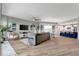 Open living room with a large sectional sofa, modern ceiling fan, and adjacent kitchen and dining area at 501 Haben Blvd # 506, Palmetto, FL 34221