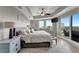 Comfortable bedroom features a tray ceiling, ceiling fan, sitting area, balcony, and views from windows at 501 Haben Blvd # 506, Palmetto, FL 34221