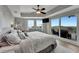 Comfortable bedroom features a tray ceiling, ceiling fan, sitting area, balcony, and panoramic views at 501 Haben Blvd # 506, Palmetto, FL 34221
