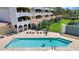 Aerial view of community pool surrounded by lush landscaping and comfortable lounge chairs at 501 Haben Blvd # 506, Palmetto, FL 34221