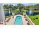 Aerial view of community pool surrounded by lush landscaping and comfortable lounge chairs at 501 Haben Blvd # 506, Palmetto, FL 34221