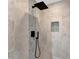 Modern shower with decorative tile accent wall, grey stone floor, and sleek fixtures at 501 Haben Blvd # 506, Palmetto, FL 34221