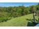 A relaxing view of the backyard landscaping including grass, bushes and trees at 5420 Eagles Point Cir # 106, Sarasota, FL 34231