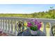 A close up of a table and chairs on the balcony, surrounded by lush landscaping at 5420 Eagles Point Cir # 106, Sarasota, FL 34231