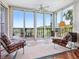 Sunny balcony with expansive windows offering views of lush surroundings at 5420 Eagles Point Cir # 106, Sarasota, FL 34231