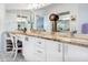 Bathroom features dual sinks with granite countertop, mirror, and white cabinets at 5420 Eagles Point Cir # 106, Sarasota, FL 34231