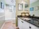 Bathroom with a tiled floor, bath tub with shower, and vanity with a black countertop at 5420 Eagles Point Cir # 106, Sarasota, FL 34231
