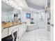 Bright bathroom with dual sinks, granite countertops, tub, and glass shower at 5420 Eagles Point Cir # 106, Sarasota, FL 34231