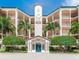 Attractive building facade with multiple balconies, palm trees, and well-manicured landscaping at 5420 Eagles Point Cir # 106, Sarasota, FL 34231