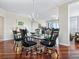 Dining room with a large glass table, hardwood floors, and traditional furnishings at 5420 Eagles Point Cir # 106, Sarasota, FL 34231