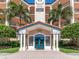 Detailed view of the condo's entrance with stately columns and manicured greenery at 5420 Eagles Point Cir # 106, Sarasota, FL 34231
