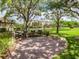 Community grill area features charcoal grills, park benches, brick pavers, landscaping and shade trees at 5420 Eagles Point Cir # 106, Sarasota, FL 34231