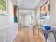 Inviting hallway with tile flooring, stylish console table, and decorative wall art at 5420 Eagles Point Cir # 106, Sarasota, FL 34231