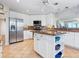 Spacious kitchen with stainless steel appliances, center island, and plenty of counter space at 5420 Eagles Point Cir # 106, Sarasota, FL 34231