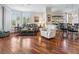 Elegant living room featuring hardwood floors, a floral sofa, and natural lighting at 5420 Eagles Point Cir # 106, Sarasota, FL 34231