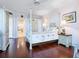 Cozy main bedroom with a four-poster bed and ensuite bathroom at 5420 Eagles Point Cir # 106, Sarasota, FL 34231