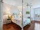 Relaxing main bedroom features a four-poster bed, ceiling fan, and a decorative rug at 5420 Eagles Point Cir # 106, Sarasota, FL 34231