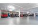 Well-lit parking garage with several parked vehicles and visible overhead pipes at 5420 Eagles Point Cir # 106, Sarasota, FL 34231