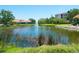 A community pond features a fountain, reeds, a manicured lawn and buildings in the background at 5420 Eagles Point Cir # 106, Sarasota, FL 34231